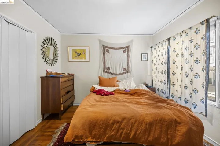 Bedroom featuring dark wood-style flooring and ornamental molding