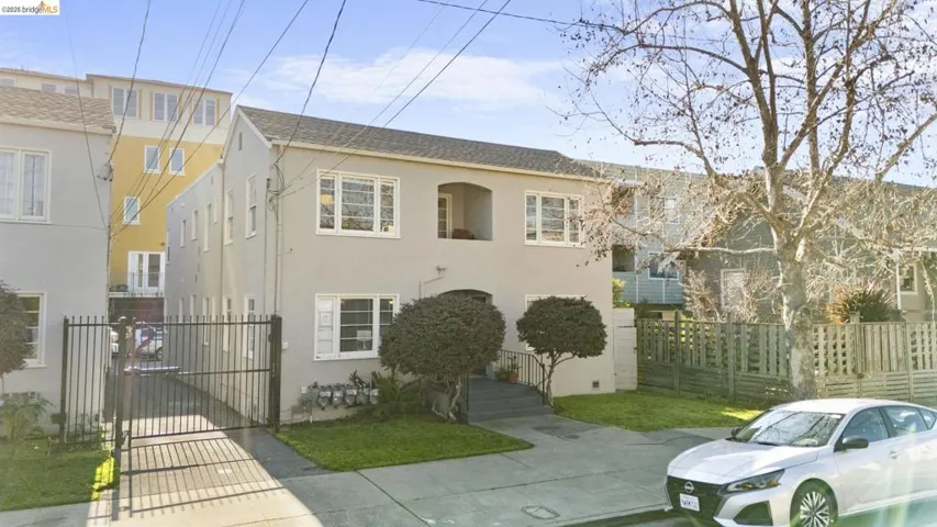 View of front of property with stucco siding and a gate