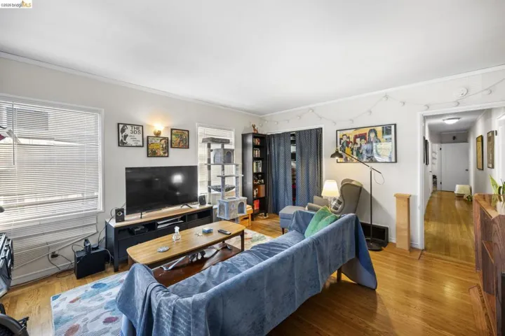 Living room featuring ornamental molding and wood finished floors