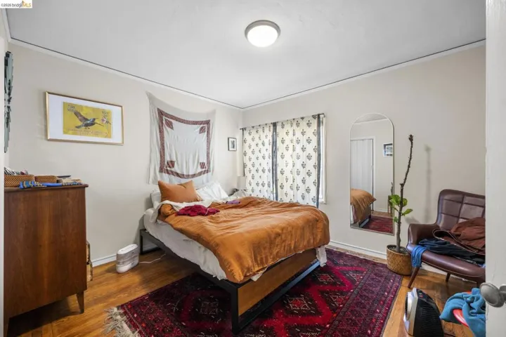 Bedroom with wood finished floors and baseboards
