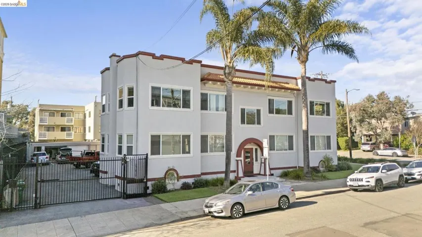 View of front of home with stucco siding and a gate