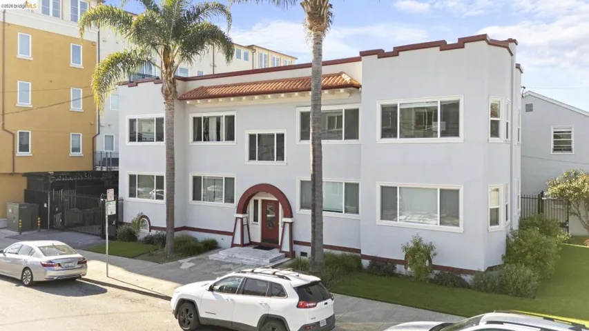 View of front facade with stucco siding and a tiled roof