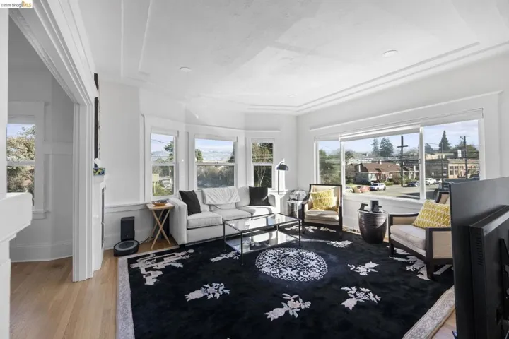 Living room with light wood-style floors and plenty of natural light