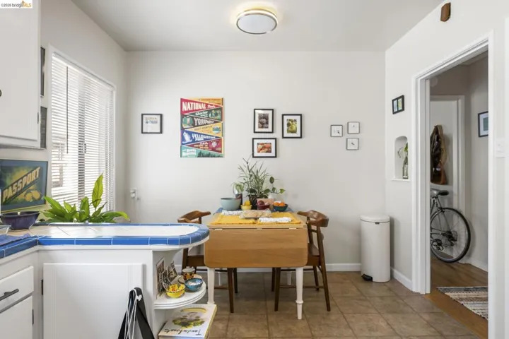 Dining room featuring light tile patterned floors and baseboards