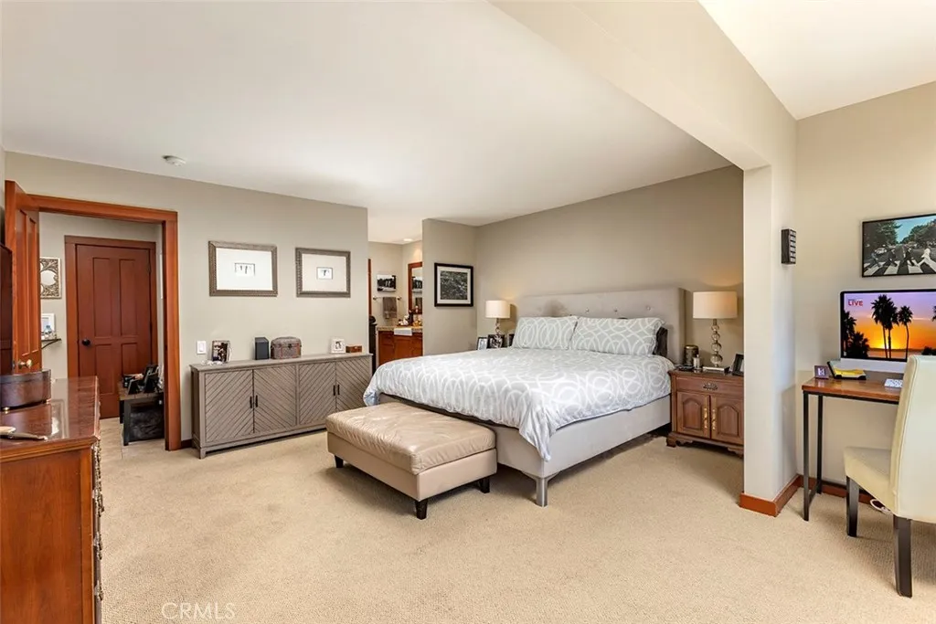 Another view of the large primary bedroom with the attached bath beyond.