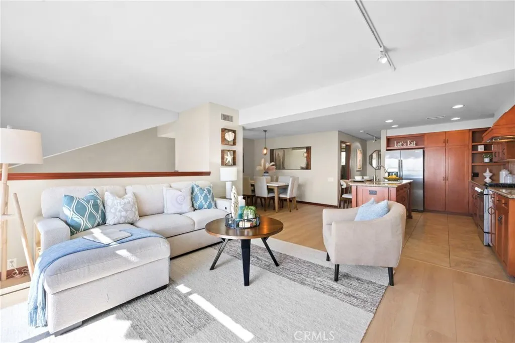 A view of the living room, kitchen and dining room.