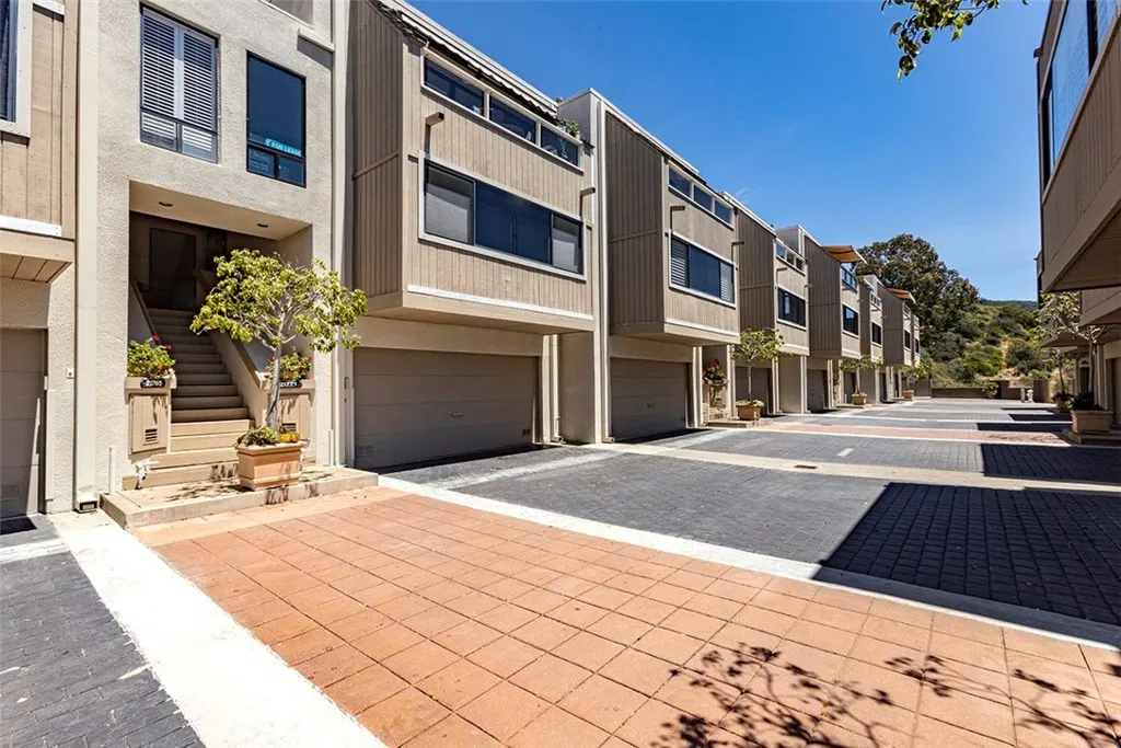 Here is a view of the 2 car garage and the entrance to the front door. The community pool is at the end of the street, 6 units down.