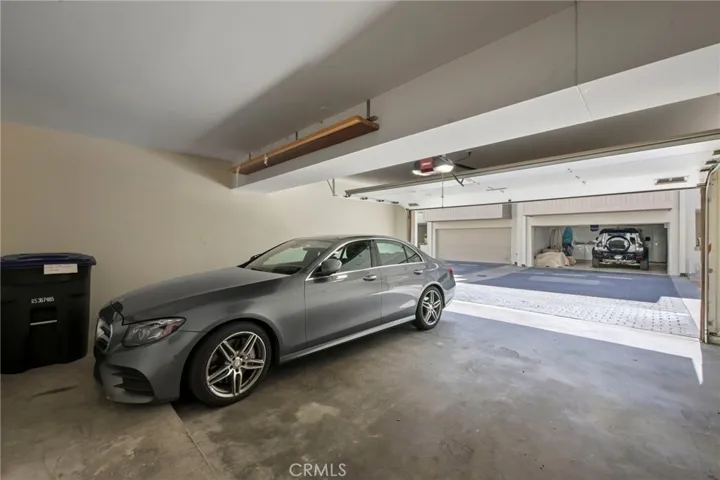 Spacious 2 car garage with storage closet and storage space on the right side of the garage.