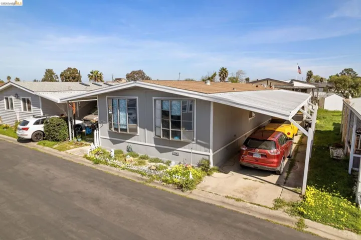 View of front of home with a carport and a metal roof
