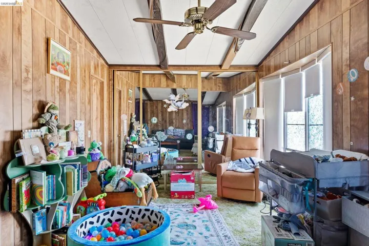Sunroom / solarium with lofted ceiling with beams