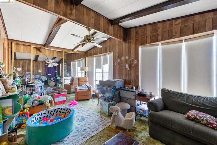 Sunroom / solarium with lofted ceiling with beams