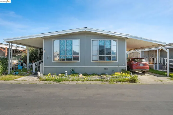 View of side of property with a carport