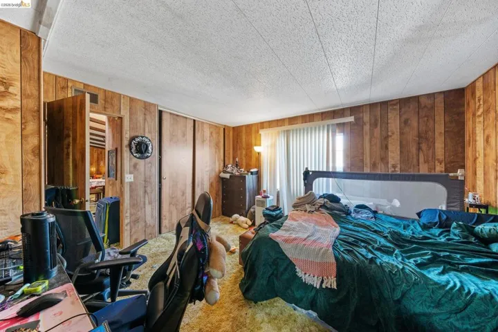 Bedroom featuring wooden walls