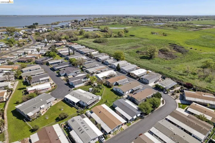 Aerial view of residential area featuring a large body of water