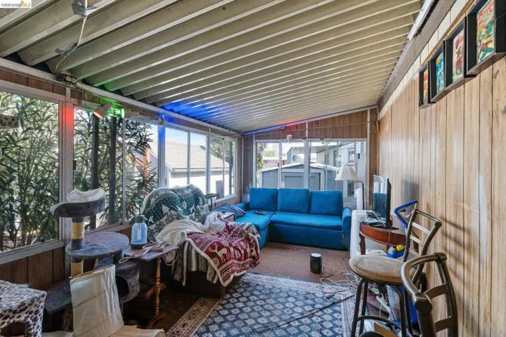 Sunroom / solarium with vaulted ceiling and an outdoor lounge area