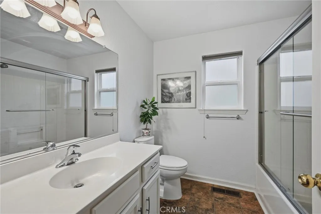 Hall bath has shower over tub.