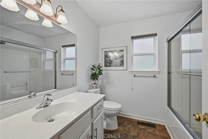 Hall bath has shower over tub.
