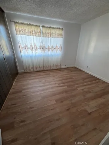 Smaller bedroom with newer laminate flooring