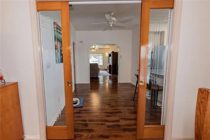 sliding woodframed doors from great room to kitchen and living room
