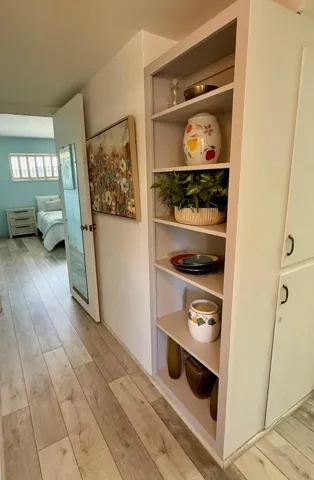 Hallway with book shelves & linen closet