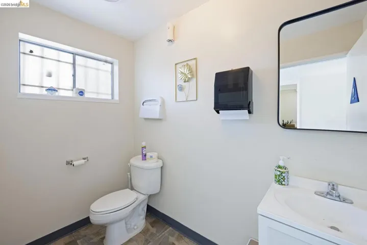 Half bathroom with toilet and vanity