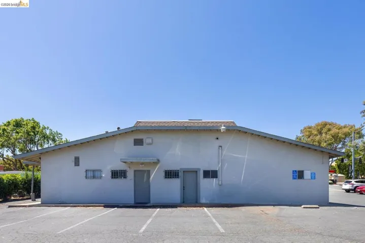 View of property featuring uncovered parking