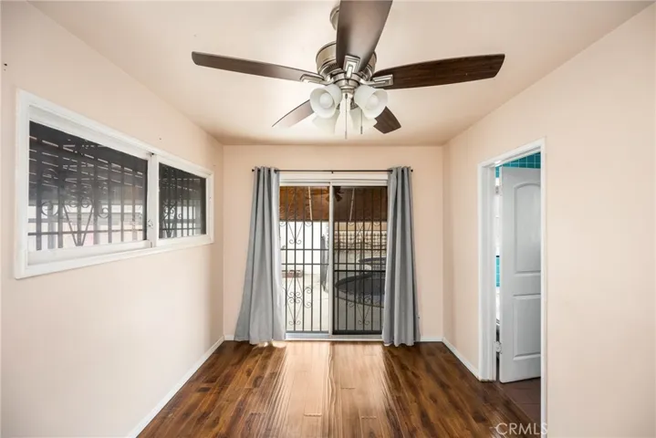 Primary bedroom with slider to backyard, door to attached bathroom and double door closet