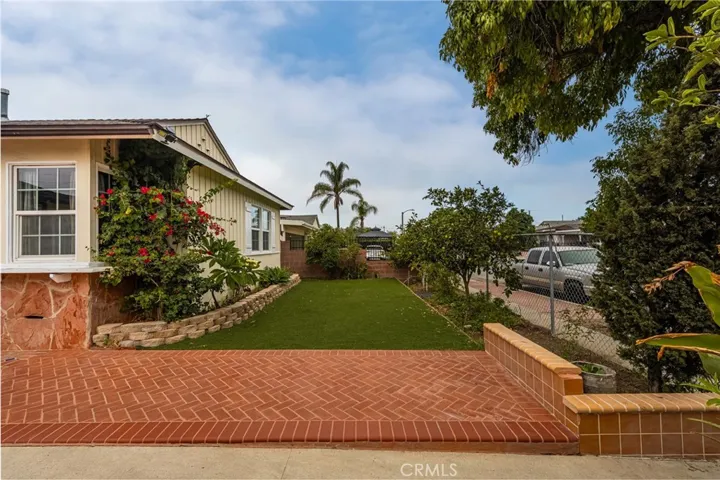 Spacious front yard with low-maintenance artificial grass