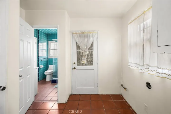 Laundry room with door to backyard
