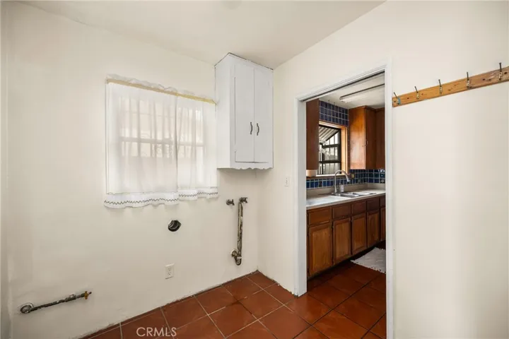 Laundry room off of kitchen and primary bedroom