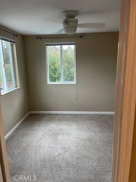 Apartment upstairs bedroom windows face street.