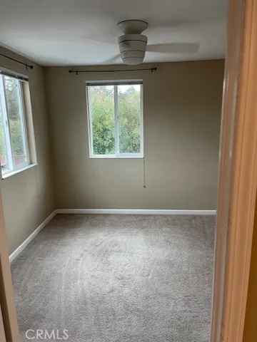 Apartment upstairs bedroom windows face street.