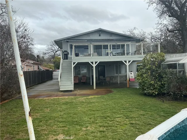 top porch, patio below, lawn with sprinker syst.