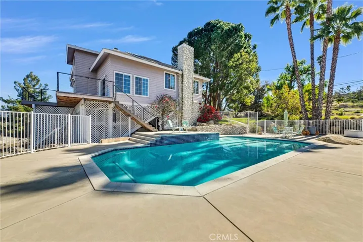 Pool deck with newly painted wrought iron fencing on all sides.  Pool is solar heated!!!