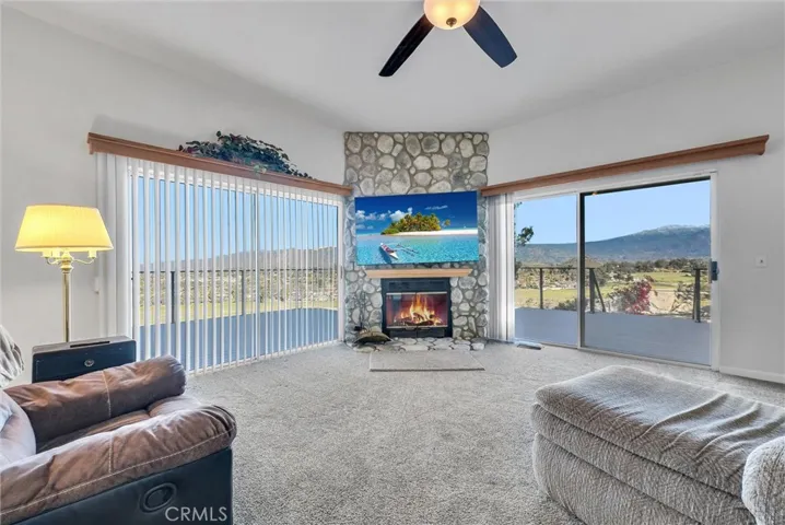 Family room with fireplace and sliders to the deck. Great views.