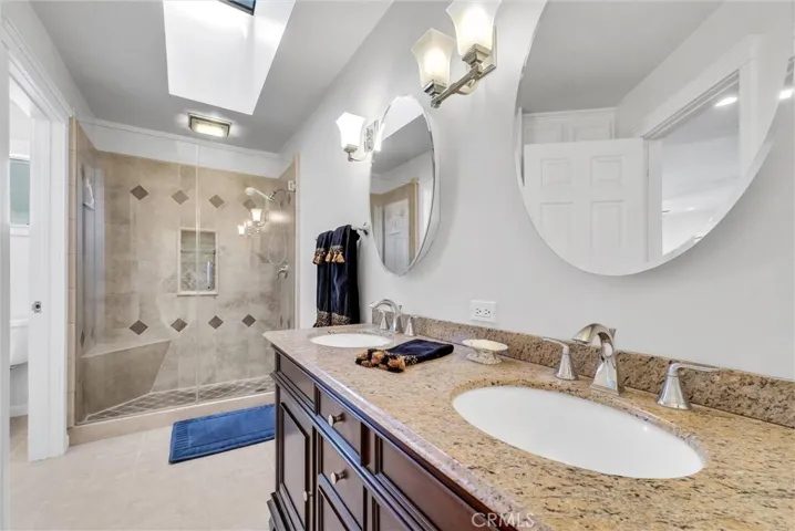 Remodeled master bath with granite counters and dual sinks.  Shower is beautiful with custom tile and a glass enclosure.  Custom cabinets are also included in this bathroom.