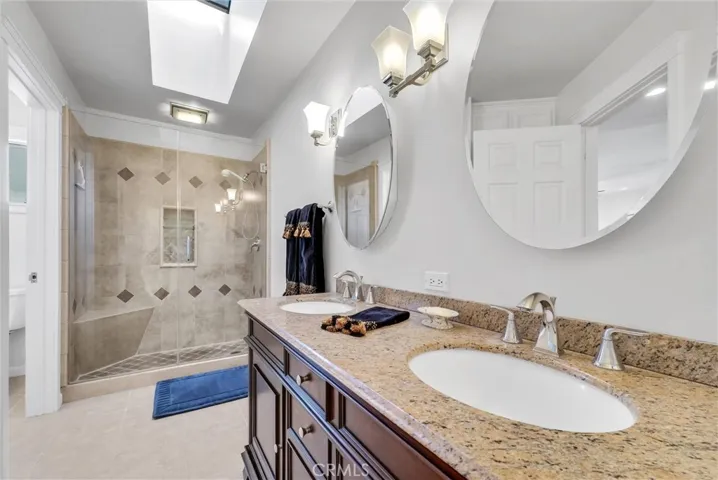 Remodeled master bath with granite counters and dual sinks.  Shower is beautiful with custom tile and a glass enclosure.  Custom cabinets are also included in this bathroom.
