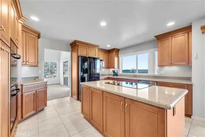 Kitchen leading into dining room.  Beautiful tile flooring.
