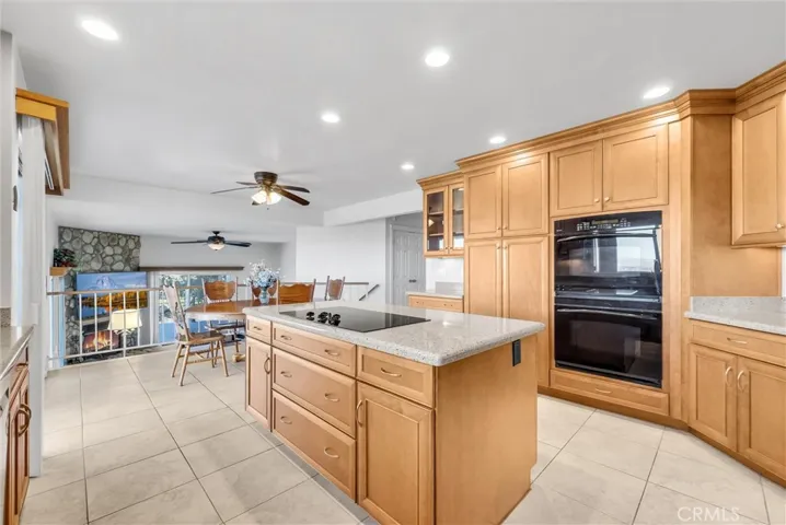 Double oven and lots of beautiful maple cabinets.