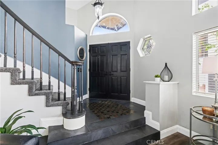 Step inside to soaring ceilings, natural light, and a grand staircase that sets the tone for the rest of the home.