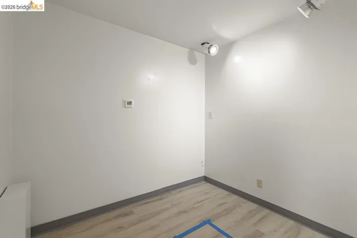 Spare room featuring light wood-style floors and baseboards