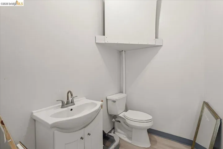 Half bath featuring toilet and vanity