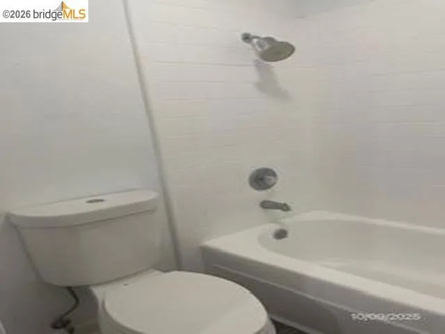 Bathroom featuring toilet and tub / shower combination