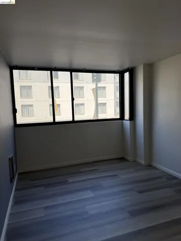 Unfurnished room featuring baseboards and wood finished floors