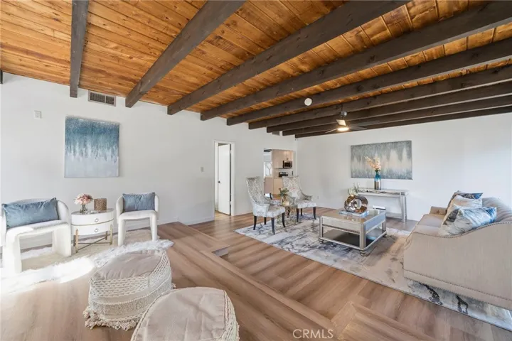 The home’s expanded family room is a standout feature, offering vaulted ceilings, a second fireplace.  This generous area creates an open and airy atmosphere. Brand new wide-plank luxury vinyl-wood flooring and Fresh Interior Paint throughout