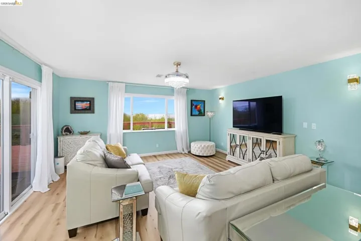 Living area with wood finished floors and a chandelier
