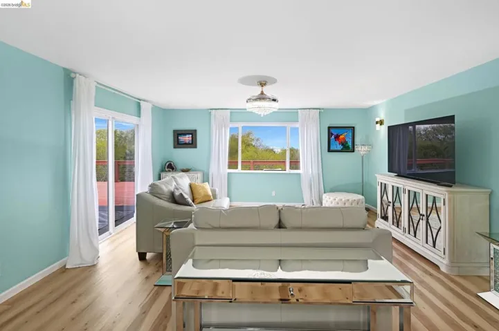 Living area featuring baseboards and light wood-style flooring