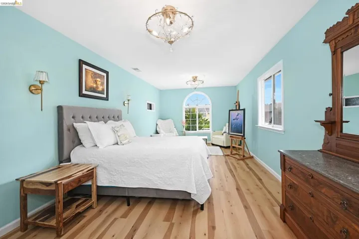 Bedroom featuring light wood finished floors and suspended lighting
