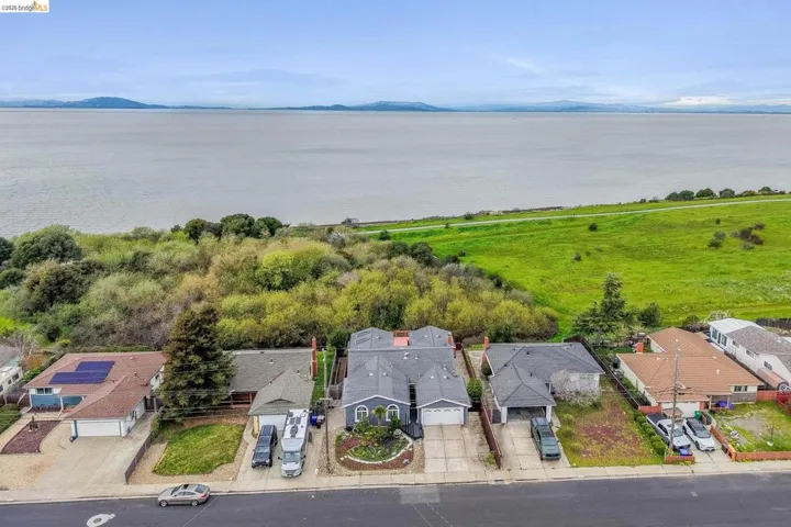Aerial perspective of suburban area featuring a water and mountain view