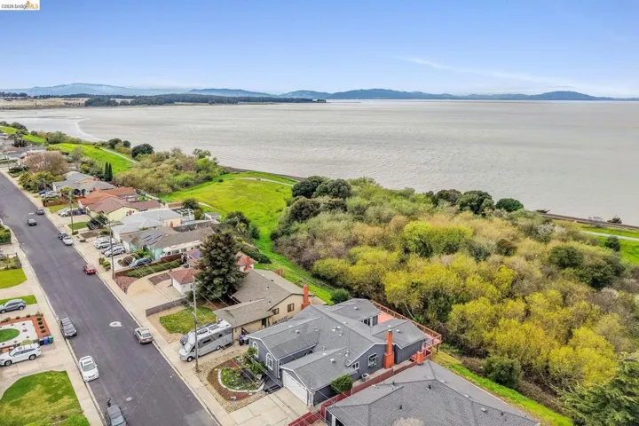 Aerial perspective of suburban area with a water and mountain view